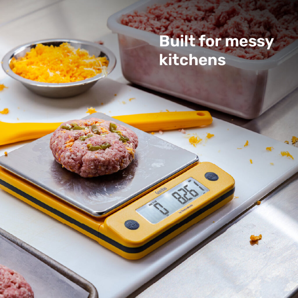 ThermoWorks Gravitas yellow scale weighing food in a messy kitchen setting
