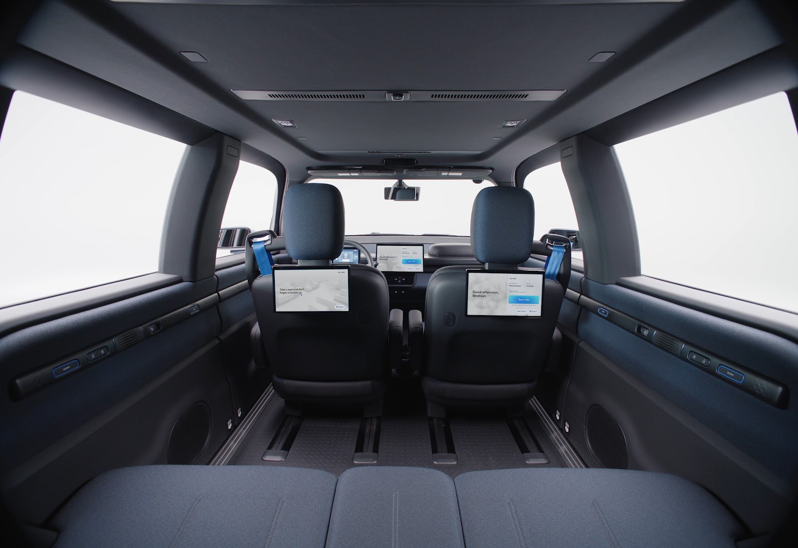 Waymo Ojai robotaxi interior showing the expansive cabin and rear passenger screens