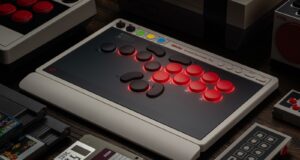 8BitDo Arcade Controller Pro leverless fight stick on a desk beside a retro console