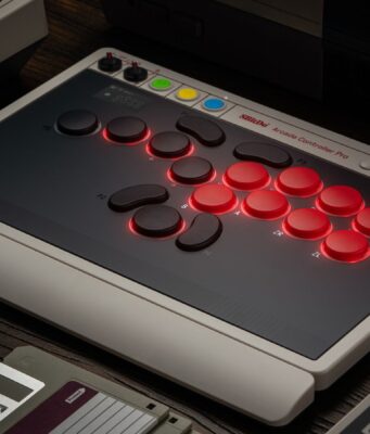 8BitDo Arcade Controller Pro leverless fight stick on a desk beside a retro console