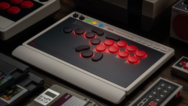 8BitDo Arcade Controller Pro leverless fight stick on a desk beside a retro console