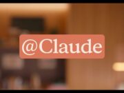 Anthropic official Claude Tag announcement graphic showing the @Claude tag over a warm office setting.