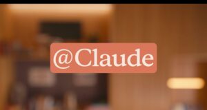 Anthropic official Claude Tag announcement graphic showing the @Claude tag over a warm office setting.