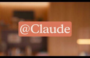 Anthropic’s Claude Tag Drops an @Claude Teammate Into Slack Anthropic official Claude Tag announcement graphic showing the @Claude tag over a warm office setting.