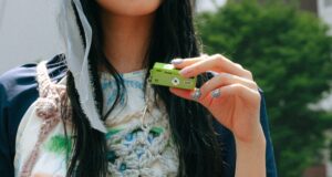 A lime-green Kodak Charmera Millennium Edition keychain camera, one of the new Y2K-inspired designs