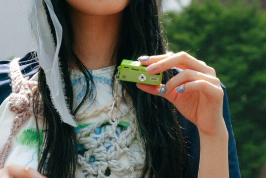 A lime-green Kodak Charmera Millennium Edition keychain camera, one of the new Y2K-inspired designs