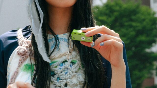 A lime-green Kodak Charmera Millennium Edition keychain camera, one of the new Y2K-inspired designs