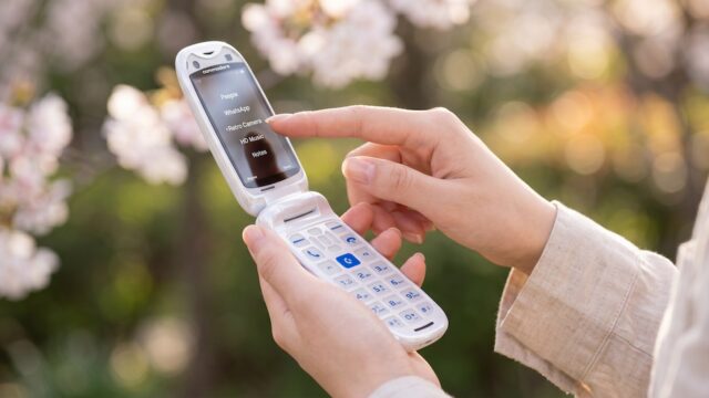 Commodore Callback 8020 flip phone open in a person's hand.
