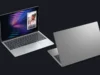 Dell XPS 13 laptop positioned against the MacBook Neo
