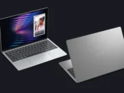 Dell XPS 13 laptop positioned against the MacBook Neo