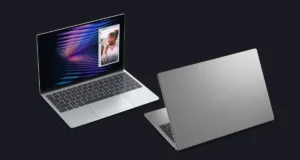 Dell XPS 13 laptop positioned against the MacBook Neo