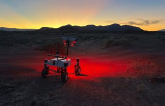 NASA ERNEST Rover Is Designed to Be Faster and Tougher NASA's ERNEST prototype rover driving across a twilight desert landscape during field testing in Southern California.