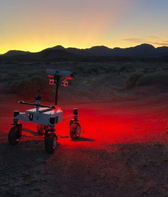 NASA ERNEST Rover Is Designed to Be Faster and Tougher NASA's ERNEST prototype rover driving across a twilight desert landscape during field testing in Southern California.