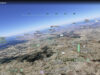Google Earth flight simulator screenshot showing an aerial view of Mexico City inside a web browser.