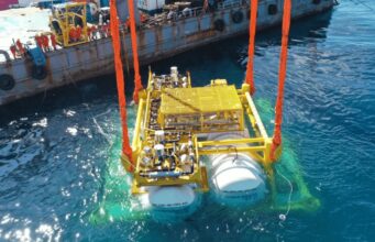 Hailanyun underwater data center module being lowered into the sea from a barge