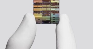 IBM researcher holding a sub-1 nanometer node chip