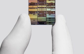 IBM researcher holding a sub-1 nanometer node chip
