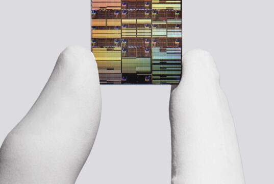 IBM researcher holding a sub-1 nanometer node chip
