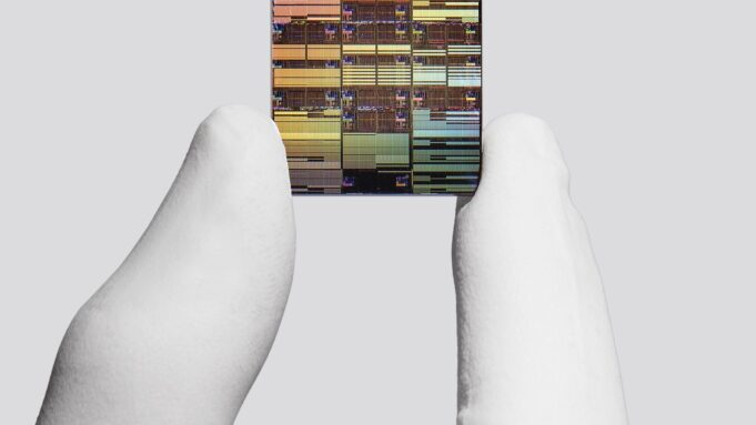IBM researcher holding a sub-1 nanometer node chip