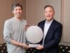 Sam Altman and Broadcom president Hock Tan holding the OpenAI Jalapeno inference chip wafer