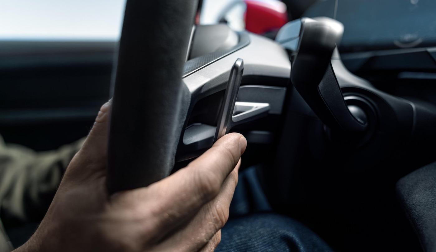 Close-up of Porsche Taycan E-Shift steering-wheel paddles.