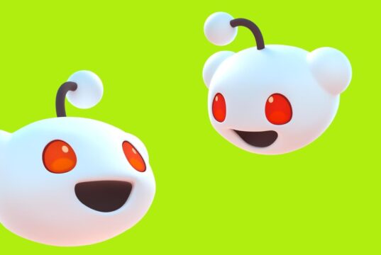 Two 3D Reddit Snoo mascots facing each other on a bright green background