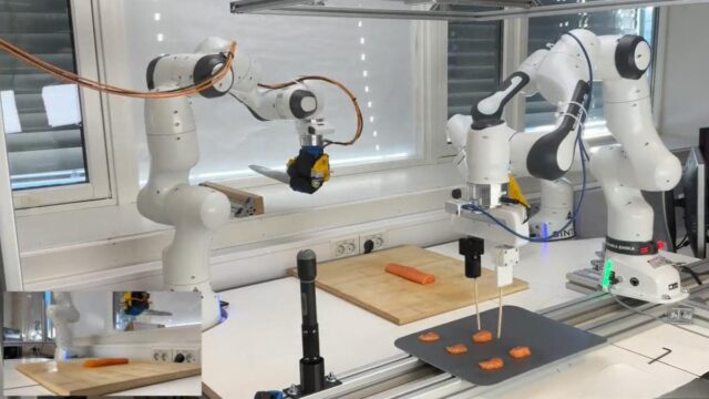 The Sashimi-Bot robot chef prepares slices of raw salmon on a cutting board.