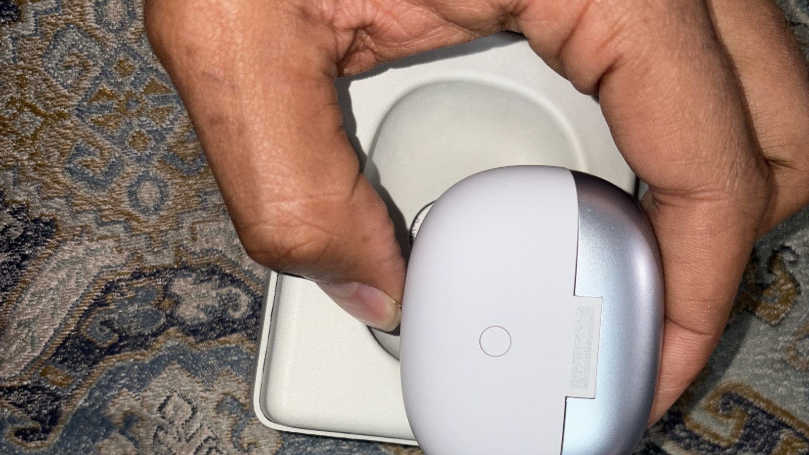 Shokz OpenDots 2 charging case held in hand in 16:9 format