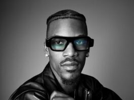 Model wearing Snap Specs AR glasses in an official black-and-white product portrait.