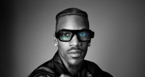 Model wearing Snap Specs AR glasses in an official black-and-white product portrait.