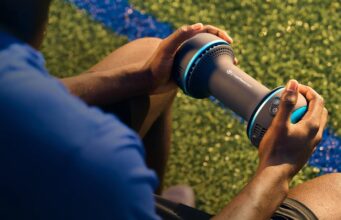 Therabody CryoTherm Palm handheld recovery device being used