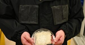 Water-harvesting jacket prototype with hydrogel panels and a fabric sample at UT Austin