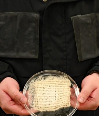 This UT Austin Jacket Harvests Drinking Water Straight From the Air Water-harvesting jacket prototype with hydrogel panels and a fabric sample at UT Austin