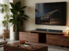 WiiM Bar Dolby Atmos soundbar shown below a TV in a living room