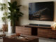 WiiM Bar Dolby Atmos soundbar shown below a TV in a living room
