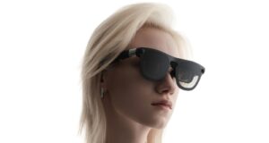 Woman wearing XREAL Aura Android XR glasses in a close-up official XREAL product image.