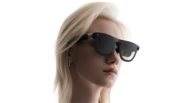 Woman wearing XREAL Aura Android XR glasses in a close-up official XREAL product image.