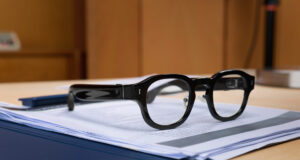 Halliday G2 AI glasses resting on documents on a desk
