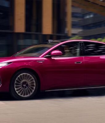 BYD Seal 08 Launches in China at $13,500 Less Than a Comparable Model 3 BYD Seal 08 sedan in magenta finish, side profile driving through a city street