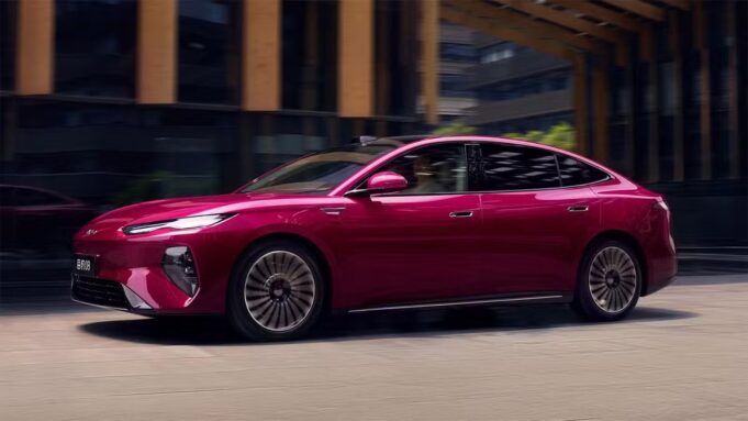 BYD Seal 08 Launches in China at $13,500 Less Than a Comparable Model 3 BYD Seal 08 sedan in magenta finish, side profile driving through a city street