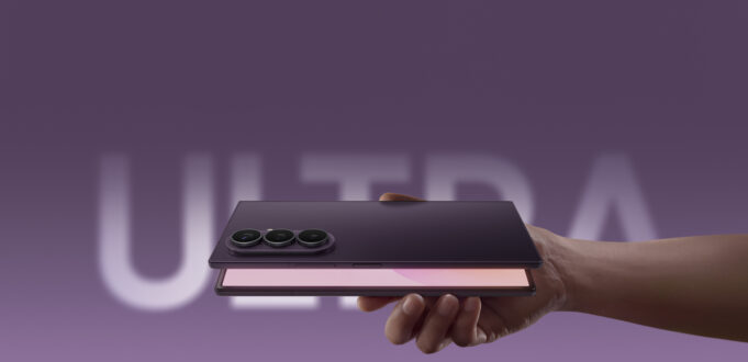 Samsung Galaxy Z Fold8 Ultra held in hand showing triple camera and open foldable display