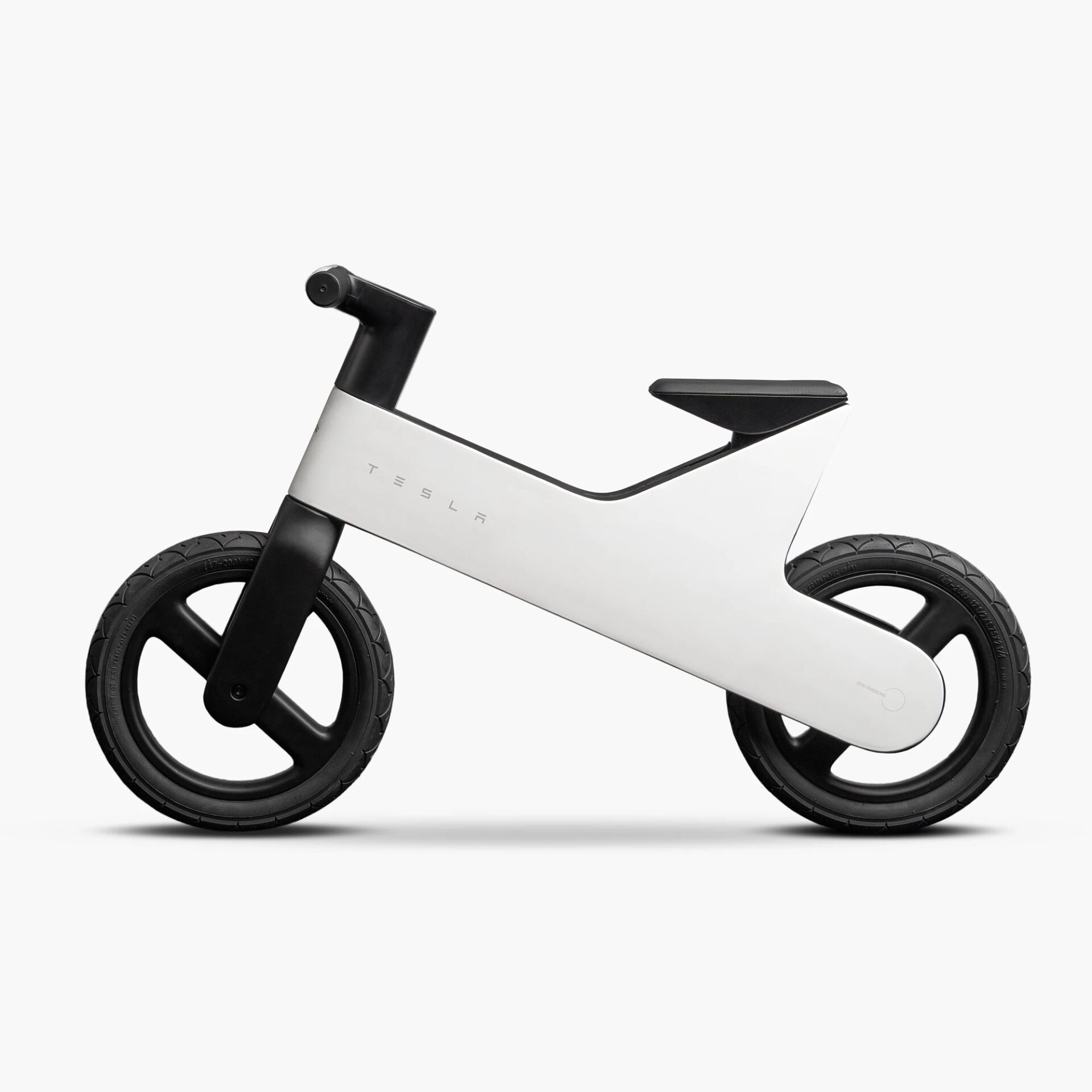 Tesla Balance Bike for Kids official product photo with white magnesium frame and black seat