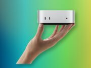 A hand holding Apple M6 Mac mini with its front USB-C ports and headphone jack