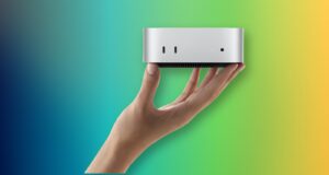 Apple M6 Mac mini and M5 Ultra Mac Studio Are Here A hand holding Apple M6 Mac mini with its front USB-C ports and headphone jack