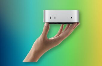 Apple M6 Mac mini and M5 Ultra Mac Studio Are Here A hand holding Apple M6 Mac mini with its front USB-C ports and headphone jack