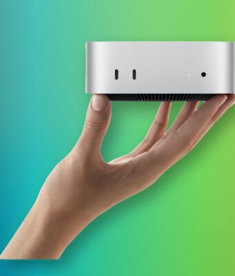 Apple M6 Mac mini and M5 Ultra Mac Studio Are Here A hand holding Apple M6 Mac mini with its front USB-C ports and headphone jack
