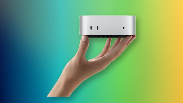 A hand holding Apple M6 Mac mini with its front USB-C ports and headphone jack