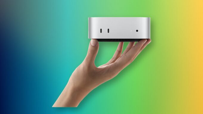 Apple M6 Mac mini and M5 Ultra Mac Studio Are Here A hand holding Apple M6 Mac mini with its front USB-C ports and headphone jack