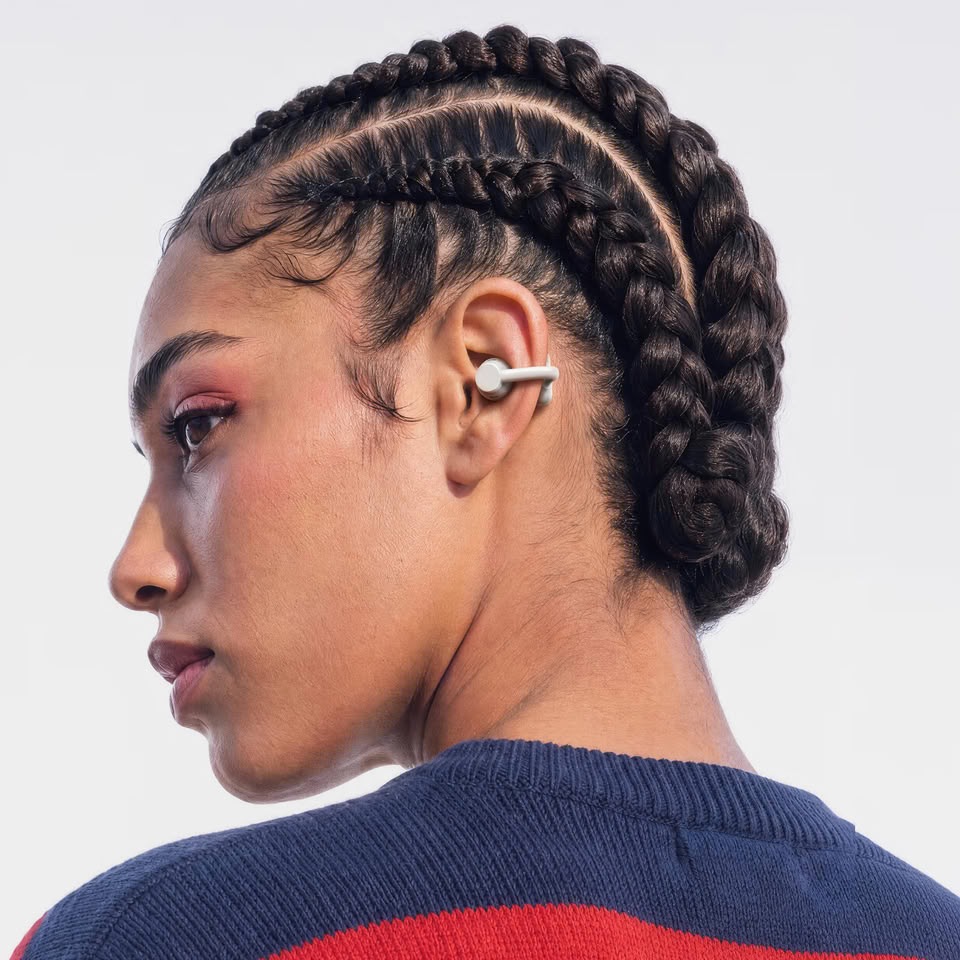 Woman wearing a light grey CMF Clip Pro open-ear earbud on her right ear