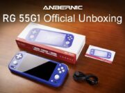 Indigo Anbernic RG 55G1 on a wood table with retail box, user manual, and USB cable